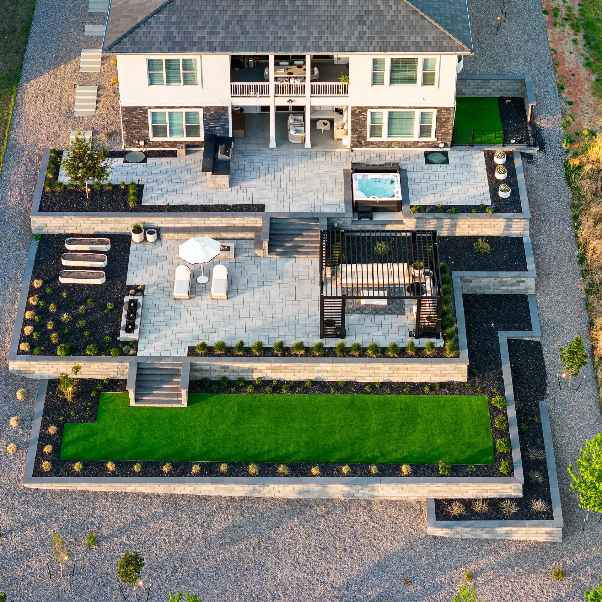 Direct overhead aerial view of a symmetrical multi-tiered patio featuring a pergola